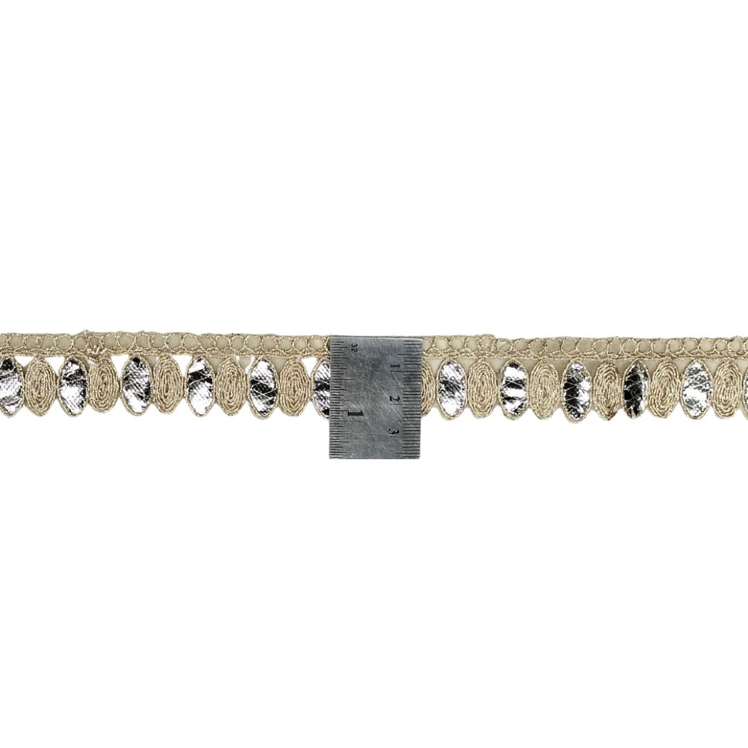 Decorative trim with crystals and gold lace on a white background